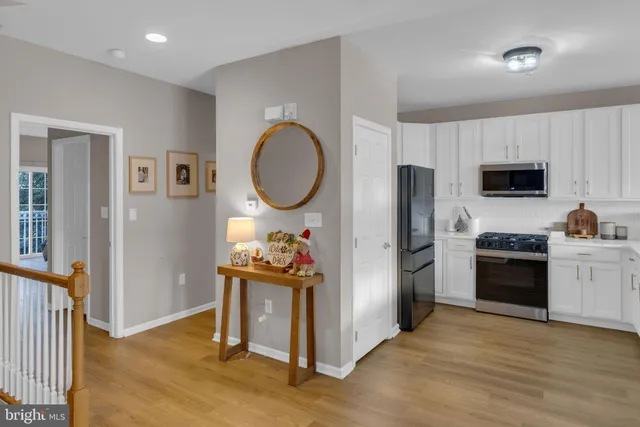 a kitchen with a refrigerator and a stove top oven
