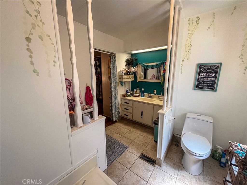 4041 Pedley Road, Unit 93 Riverside, CA 92509 - Photo 16 of 27 a bathroom with a toilet sink and mirror