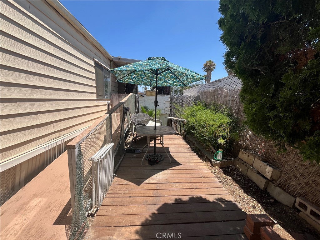 4041 Pedley Road, Unit 93 Riverside, CA 92509 - Photo 26 of 27 a view of a balcony with chairs and potted plants