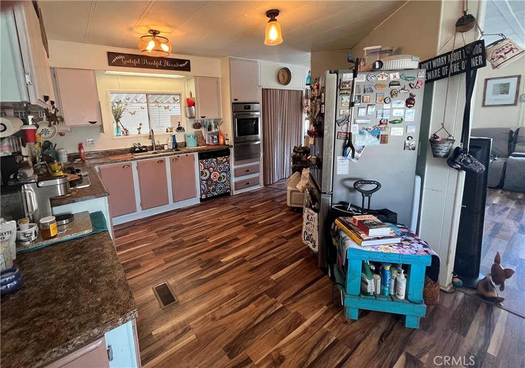 4041 Pedley Road, Unit 93 Riverside, CA 92509 - Photo 8 of 27 a room with wooden floors and lots of furniture