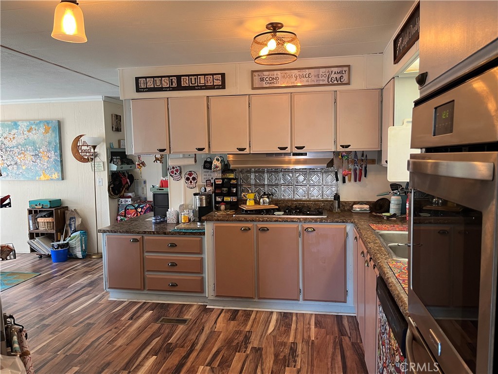 4041 Pedley Road, Unit 93 Riverside, CA 92509 - Photo 9 of 27 a kitchen with stainless steel appliances a stove top oven and a refrigerator