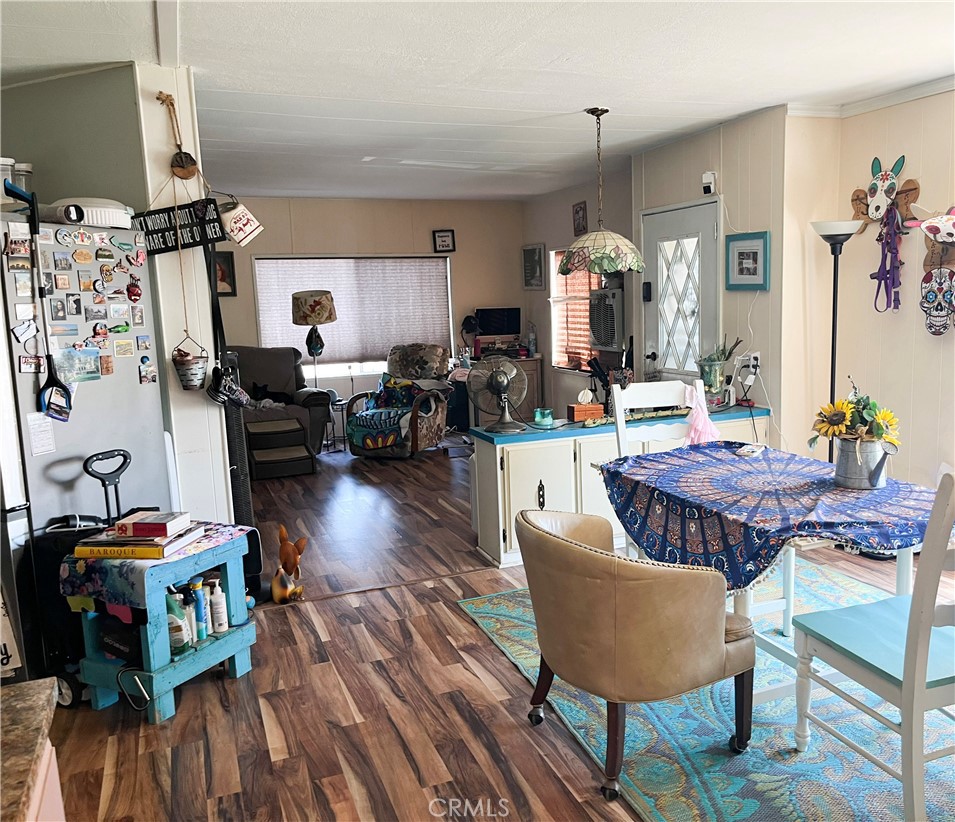 4041 Pedley Road, Unit 93 Riverside, CA 92509 - Photo 10 of 27 a living room with furniture a wooden floor and a chandelier