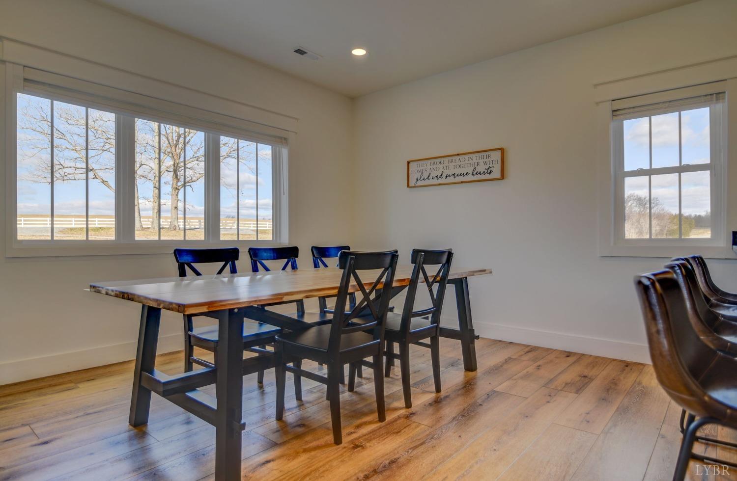 1498 Browns Mill Road Rustburg, VA 24588 - Photo 14 of 54 a view of a a dining room with furniture window and wooden floor