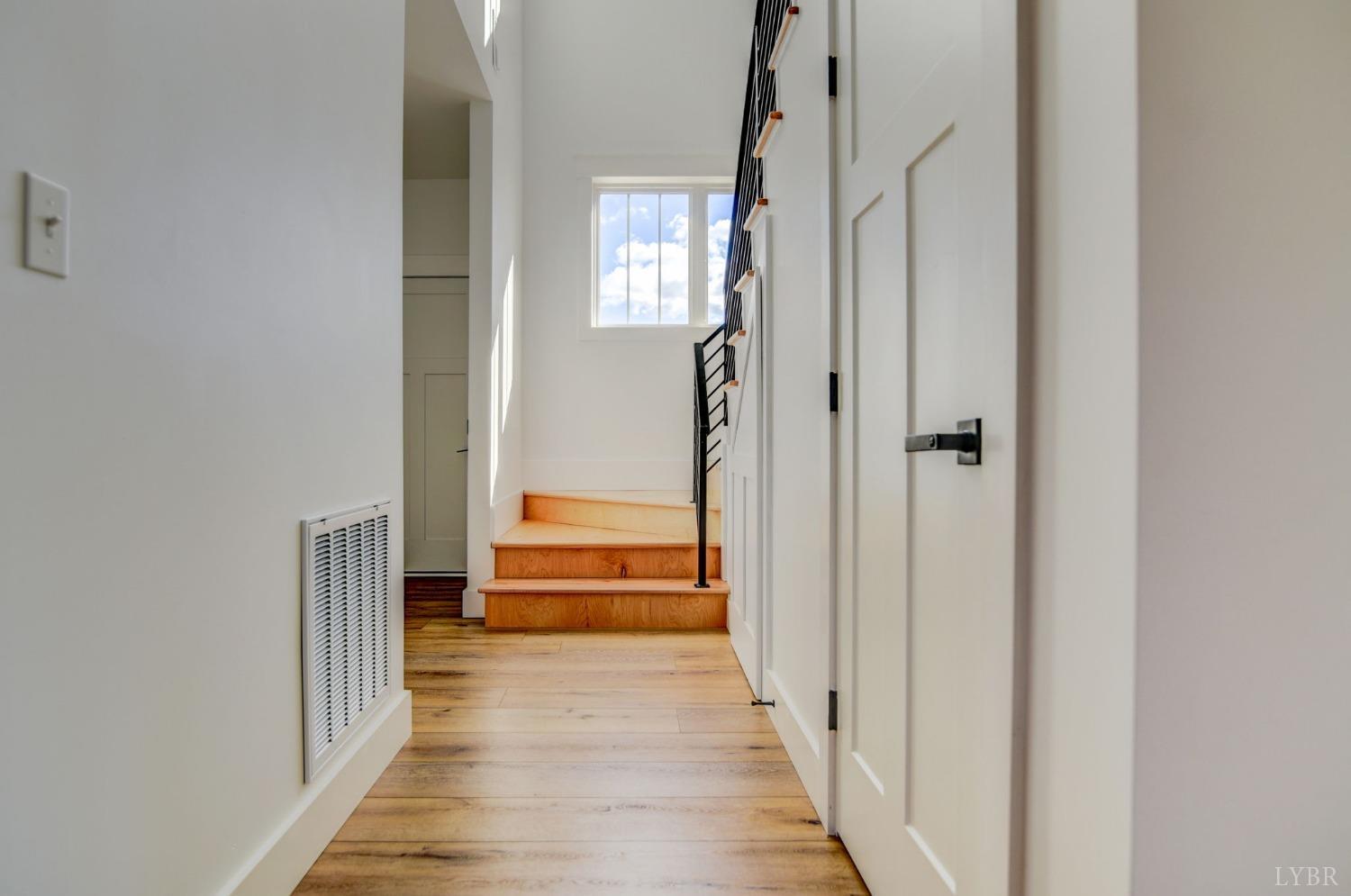1498 Browns Mill Road Rustburg, VA 24588 - Photo 16 of 54 a view of a hallway with wooden floor and a bathroom