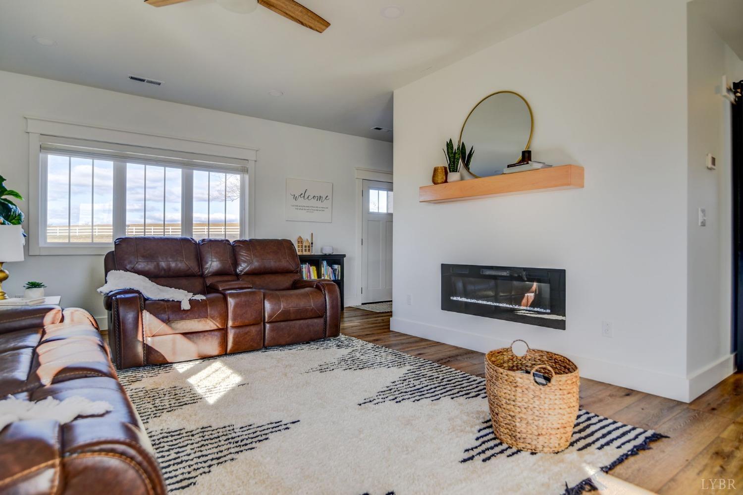 1498 Browns Mill Road Rustburg, VA 24588 - Photo 7 of 54 a living room with furniture chess board and a fireplace