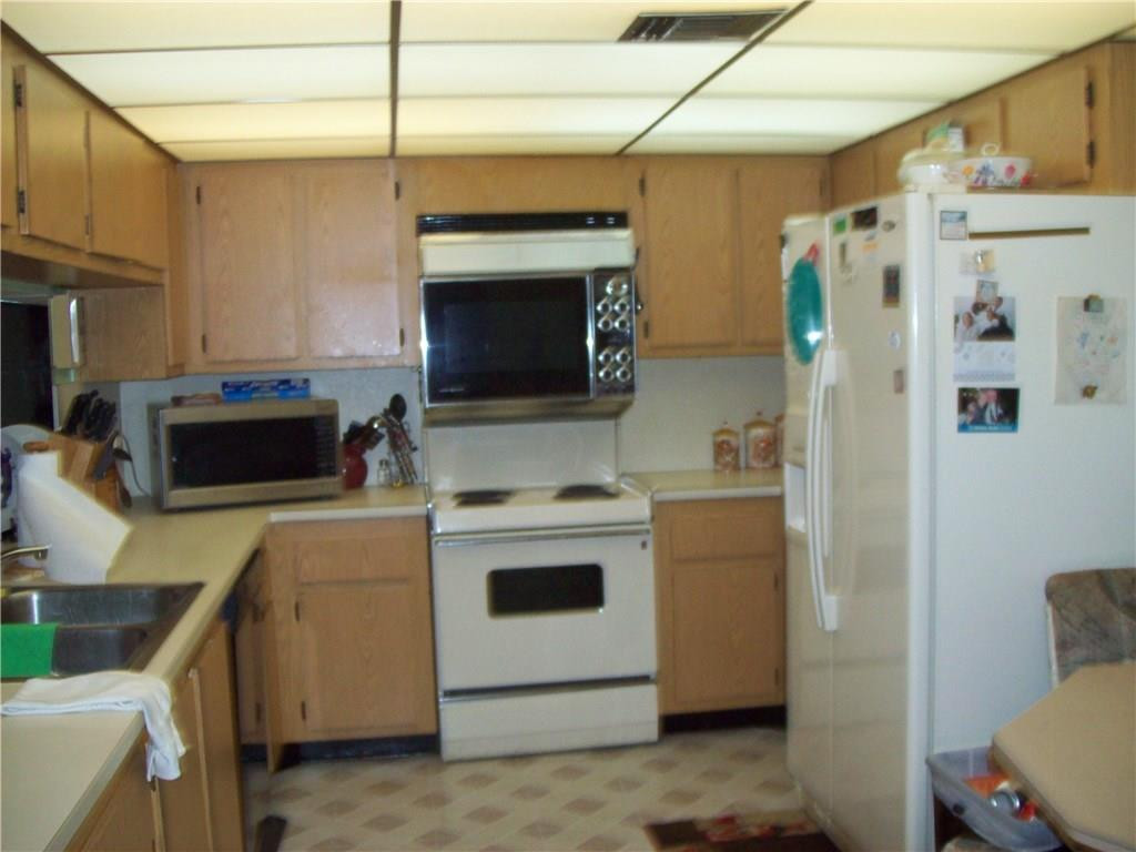 5255 Gate Lake Road, Unit 5255 Tamarac, FL 33319 - Photo 17 of 25 a kitchen with stainless steel appliances a stove a microwave and a refrigerator
