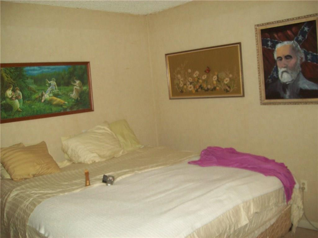 5255 Gate Lake Road, Unit 5255 Tamarac, FL 33319 - Photo 4 of 25 a bedroom with a bed and wall painting