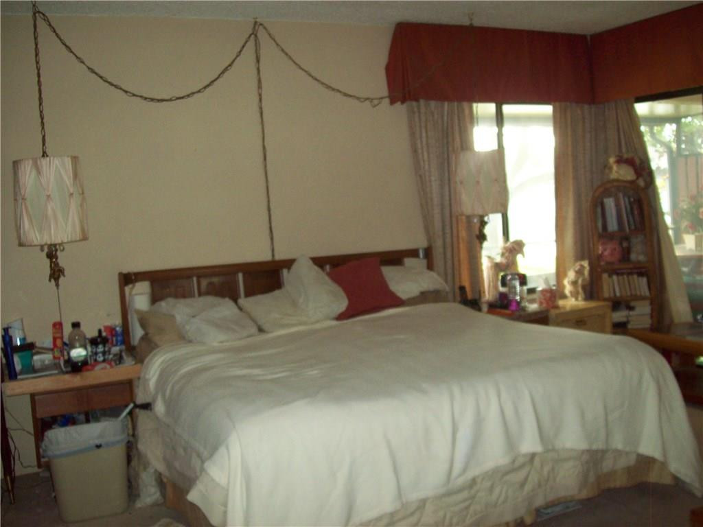 5255 Gate Lake Road, Unit 5255 Tamarac, FL 33319 - Photo 7 of 25 a bedroom with a bed and a window