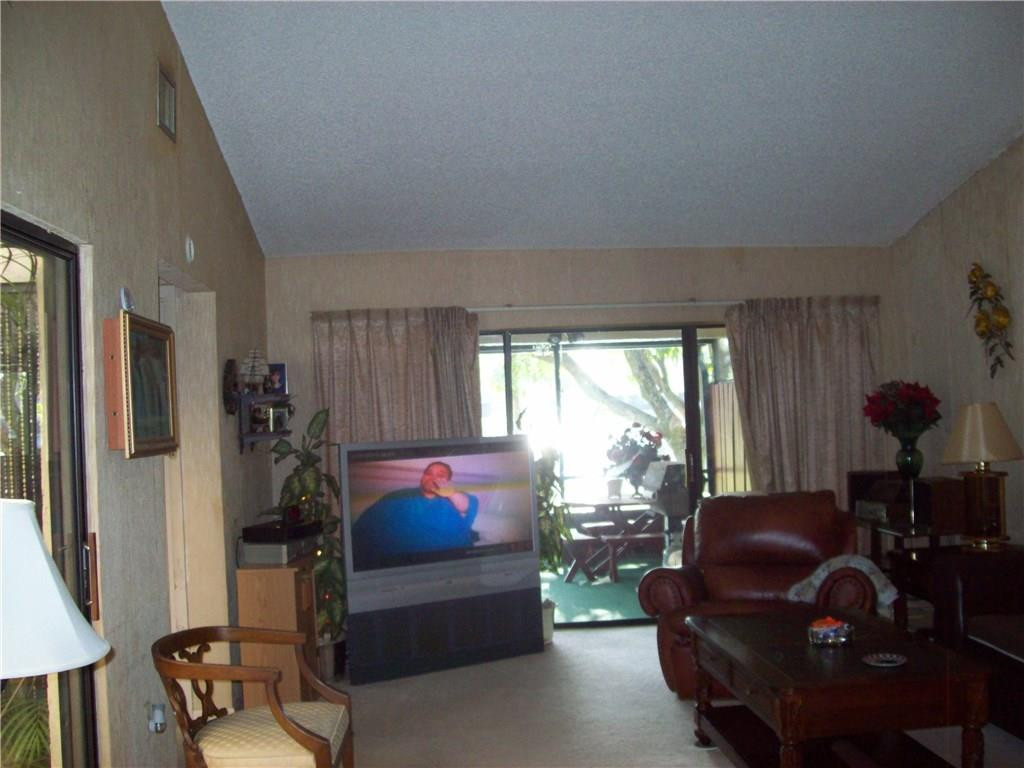 5255 Gate Lake Road, Unit 5255 Tamarac, FL 33319 - Photo 10 of 25 a living room with furniture a window and gym equipment