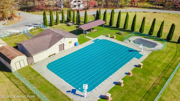 a view of a swimming pool with a yard