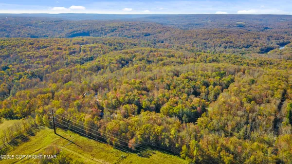a front view of a house with a yard and lake view