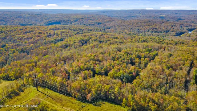 a front view of a house with a yard and lake view