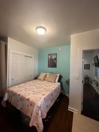 a bedroom with a bed and a dresser