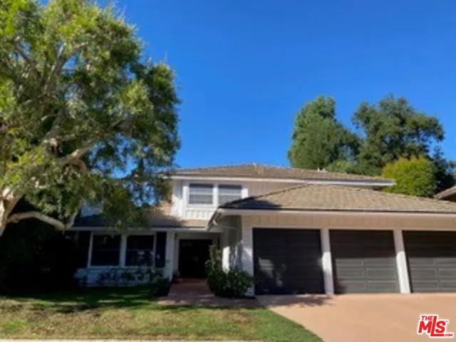 a front view of a house with a yard garage and outdoor seating