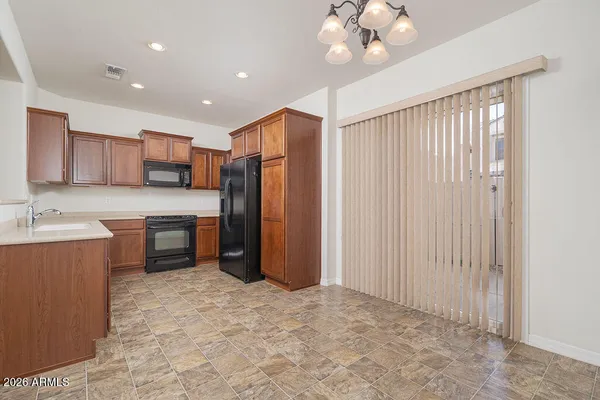 a kitchen with refrigerator and cabinets