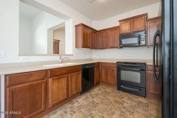 a kitchen with a sink stove and microwave
