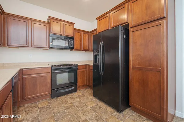a kitchen with stainless steel appliances granite countertop a refrigerator stove and sink