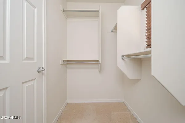 a view of walk in closet with empty racks
