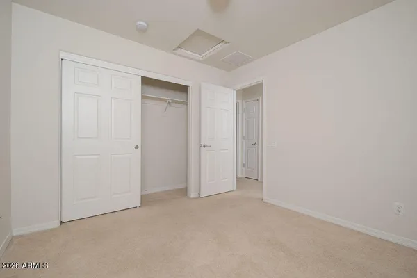 an empty room with closet area