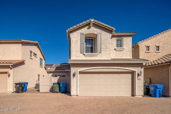 a view of a house with a garage and balcony