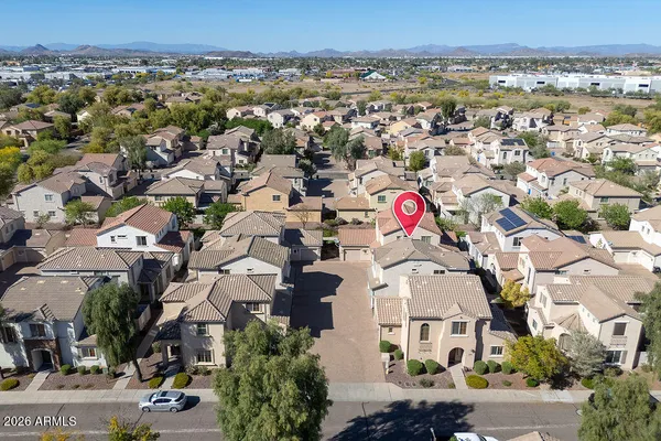an aerial view of multi story residential apartment building with parking