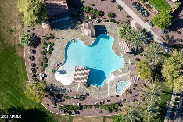 an aerial view of a house with a yard and large trees
