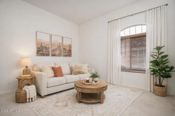 a living room with furniture and a potted plant