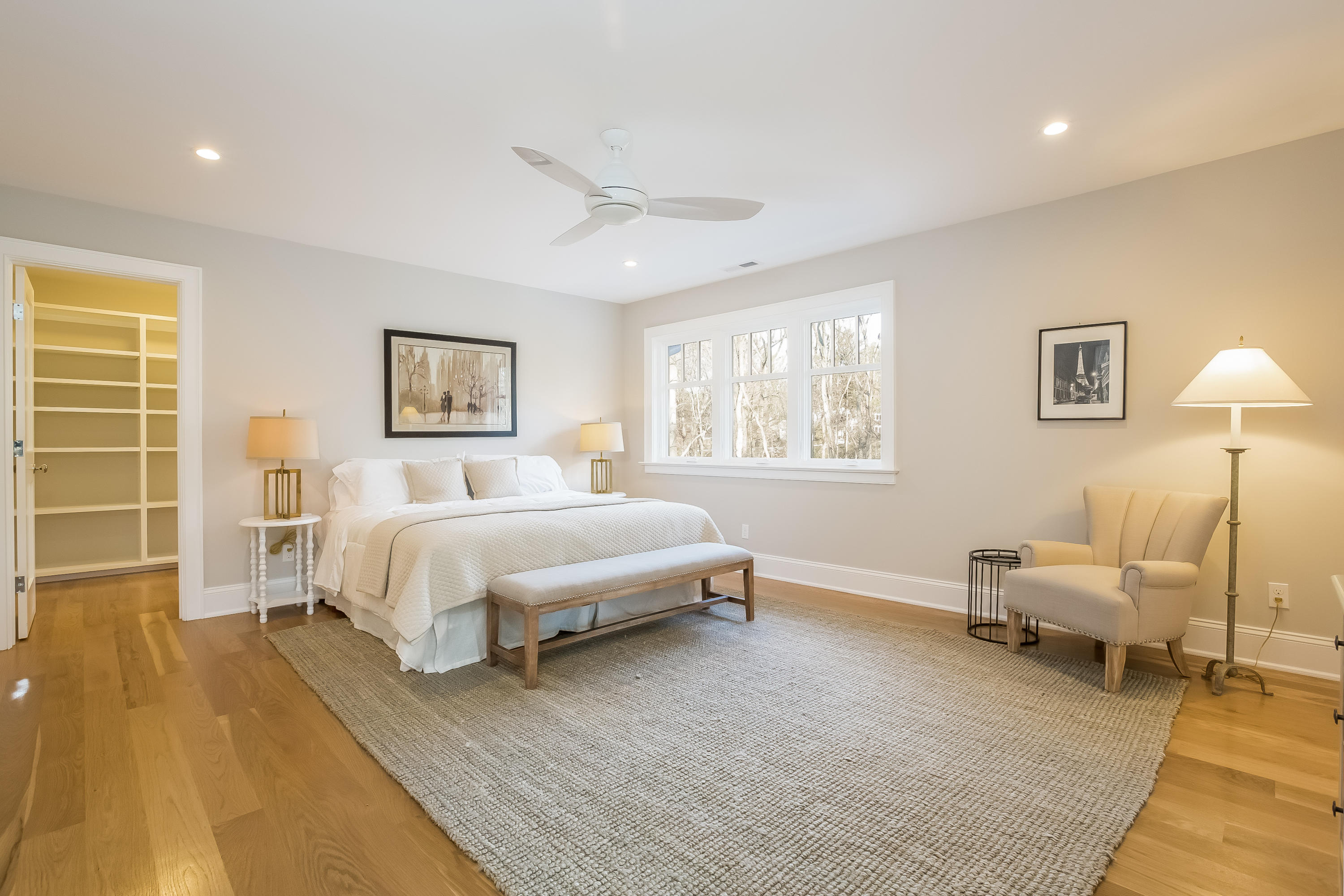 26 Range Road Rowayton, CT 06853 - Photo 13 of 26 a spacious bedroom with a bed a couch and a window