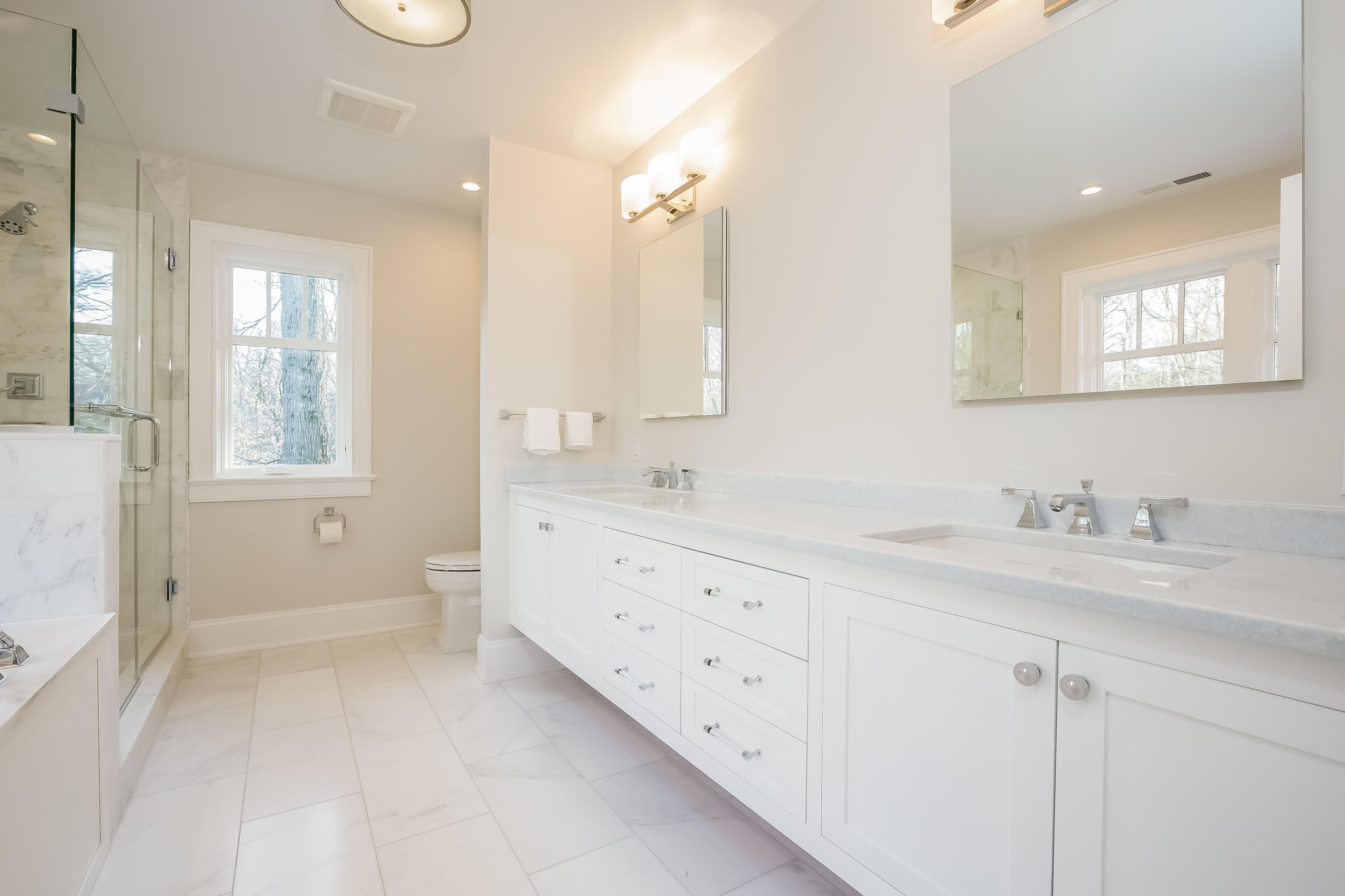 26 Range Road Rowayton, CT 06853 - Photo 14 of 26 a spacious bathroom with double sink a mirror and a shower