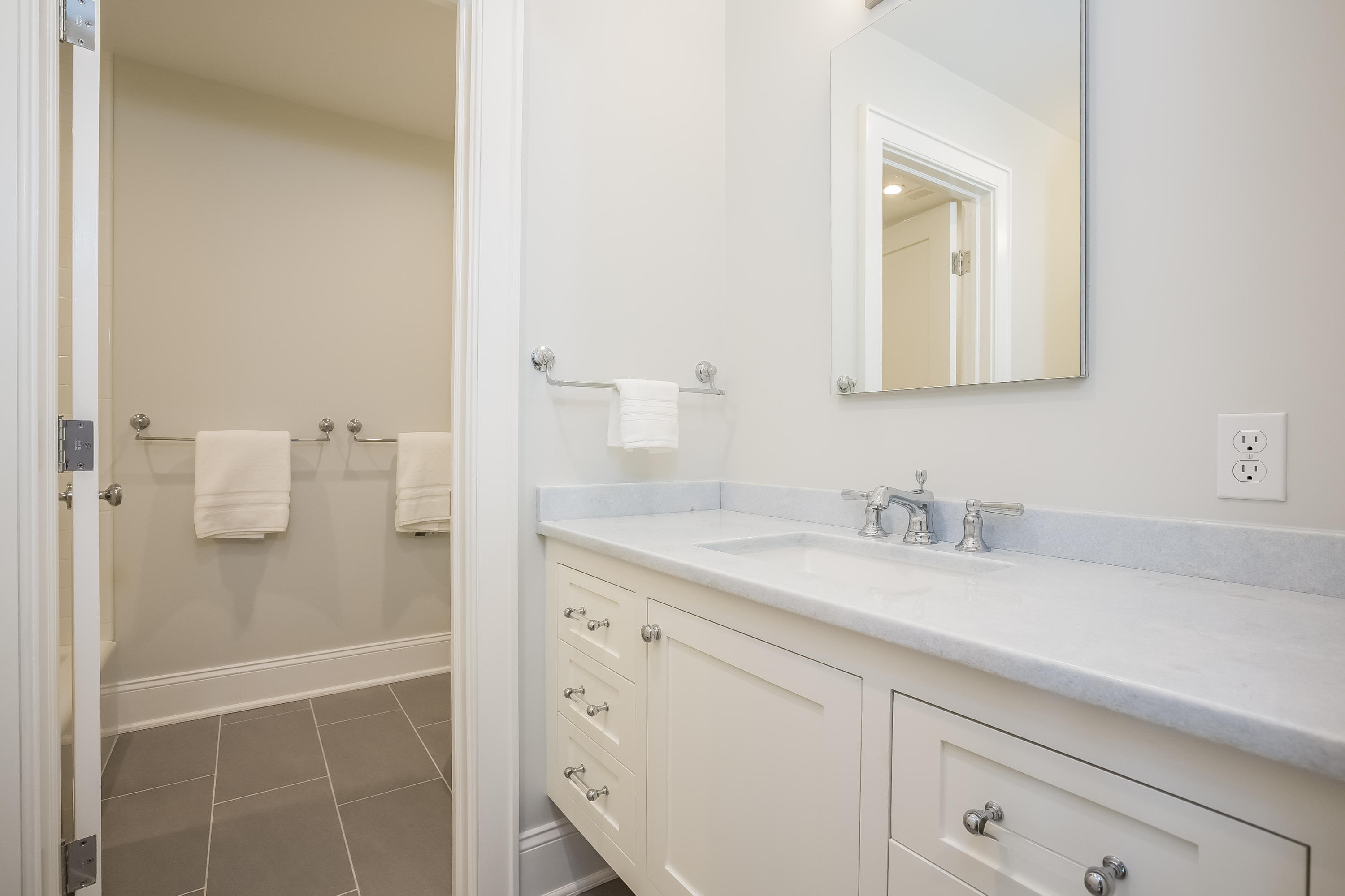 26 Range Road Rowayton, CT 06853 - Photo 19 of 26 a bathroom with a granite countertop sink and a mirror