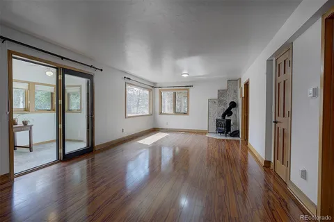a view of a workspace with furniture and wooden floor