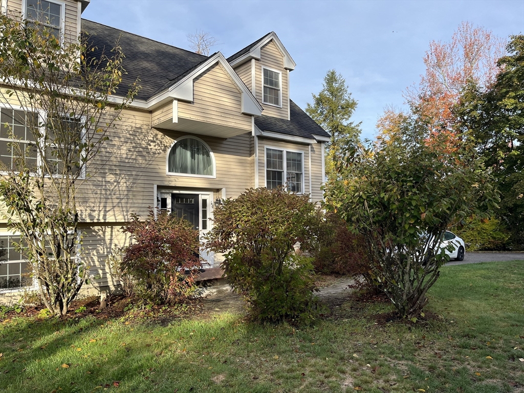 154 Prospect Street, Unit 154 Acton, MA 01720 - Photo 1 of 10 a front view of a house with garden