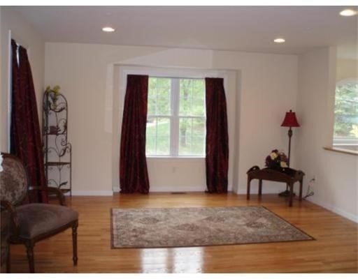154 Prospect Street, Unit 154 Acton, MA 01720 - Photo 2 of 10 a living room with furniture and a window