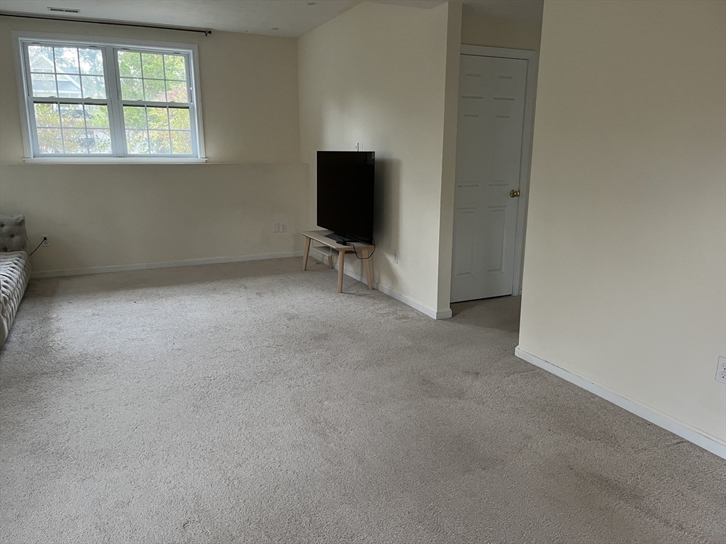 154 Prospect Street, Unit 154 Acton, MA 01720 - Photo 5 of 10 an empty room with windows