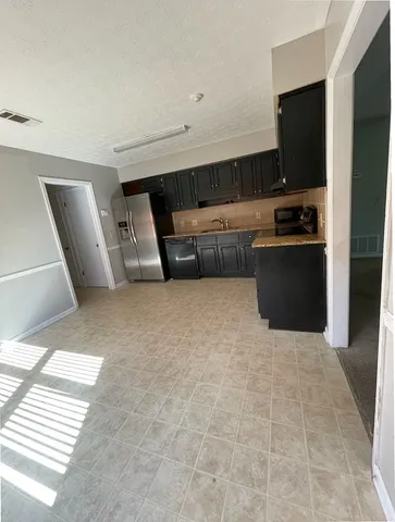a kitchen with stainless steel appliances a refrigerator and a stove
