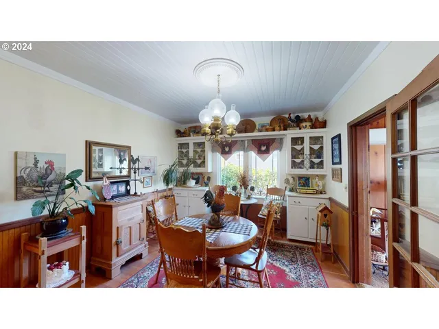 a living room with stainless steel appliances kitchen island granite countertop furniture and a chandelier