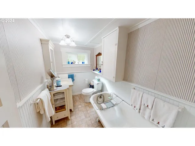 a living room with furniture a rug and white walls