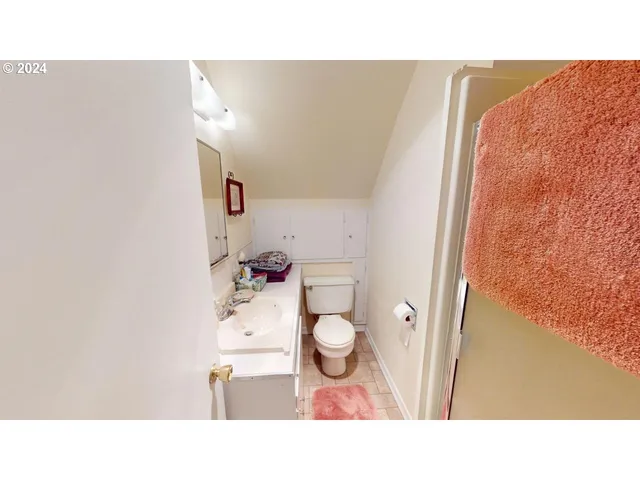 a bathroom with a sink mirror and vanity