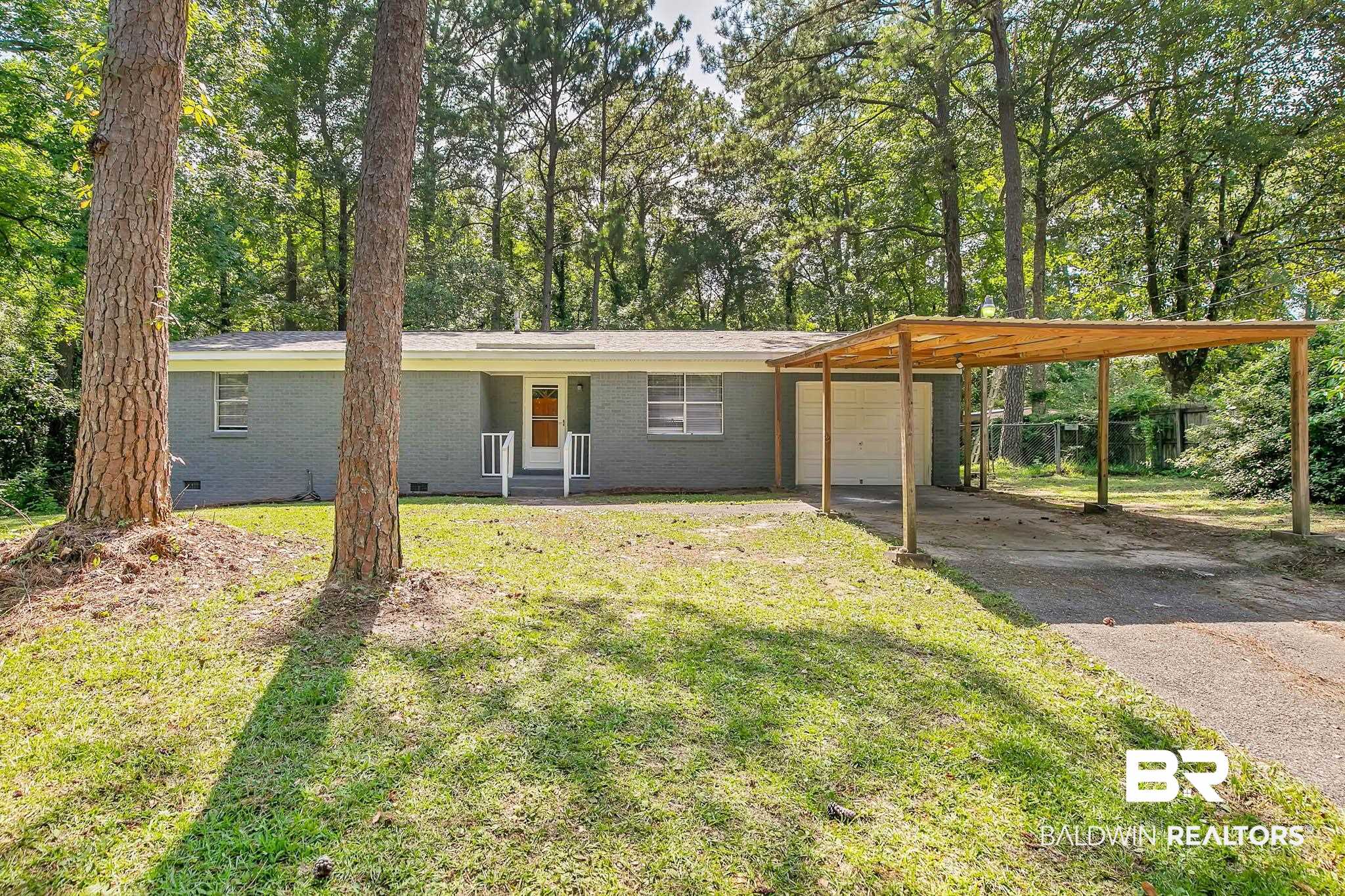 3304 Armond Drive Mobile, AL 36605 - Photo 58 of 62 View of front of property featuring crawl space, driveway, an attached garage, and brick siding