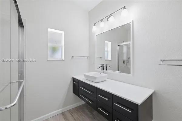 a bathroom with a sink a mirror and a vanity