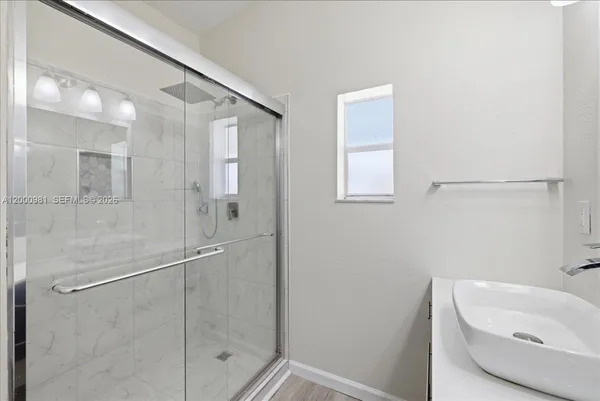a bathroom with a bathtub and shower
