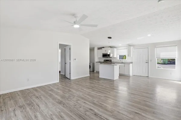 a view of a kitchen with wooden floor and a kitchen