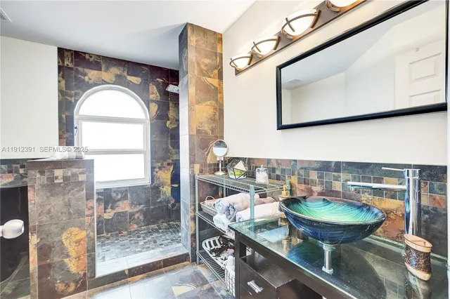 a bedroom with a bed and a tv on the dresser