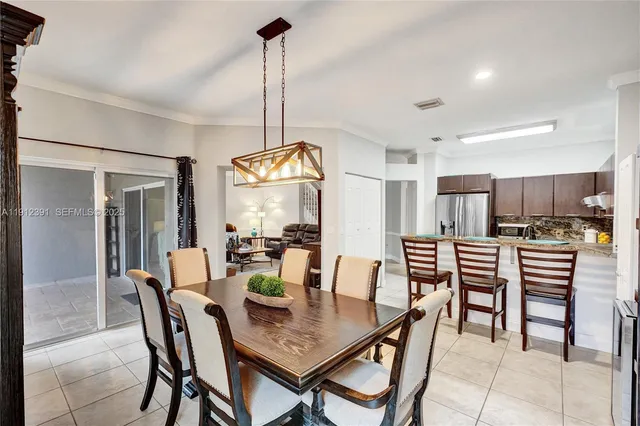 a kitchen with stainless steel appliances a refrigerator and a dining table