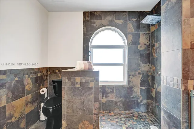 a bedroom with furniture and a mirror