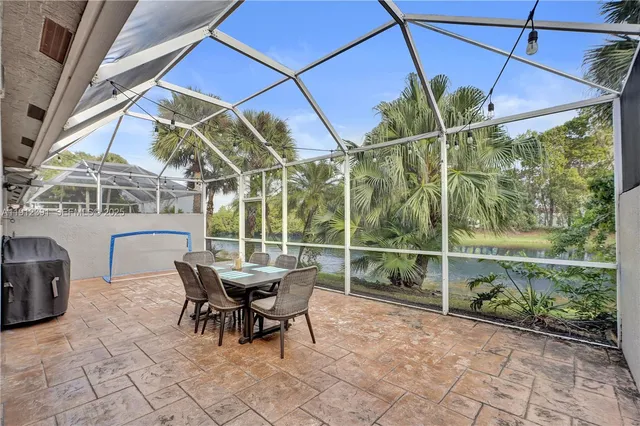 a view of a patio with a table and chairs