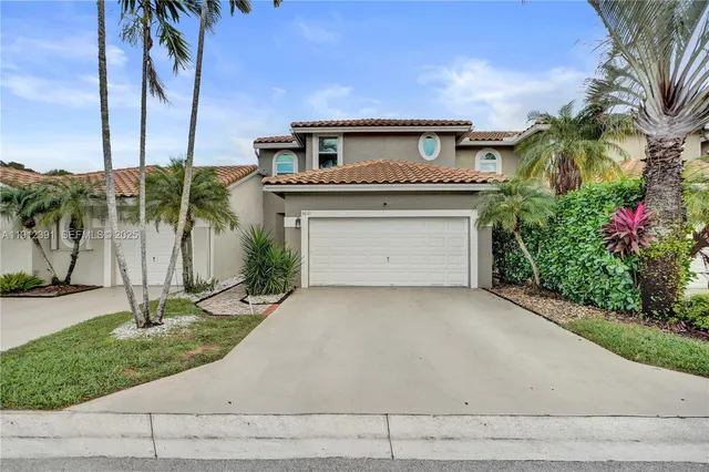 an aerial view of a city with lots of residential buildings ocean and mountain view in back