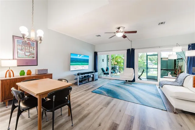 a living room with furniture a chandelier and a table