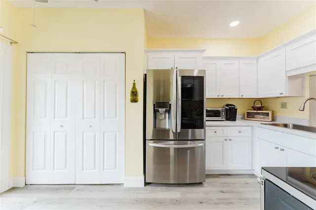 a kitchen with stainless steel appliances a refrigerator and a stove top oven