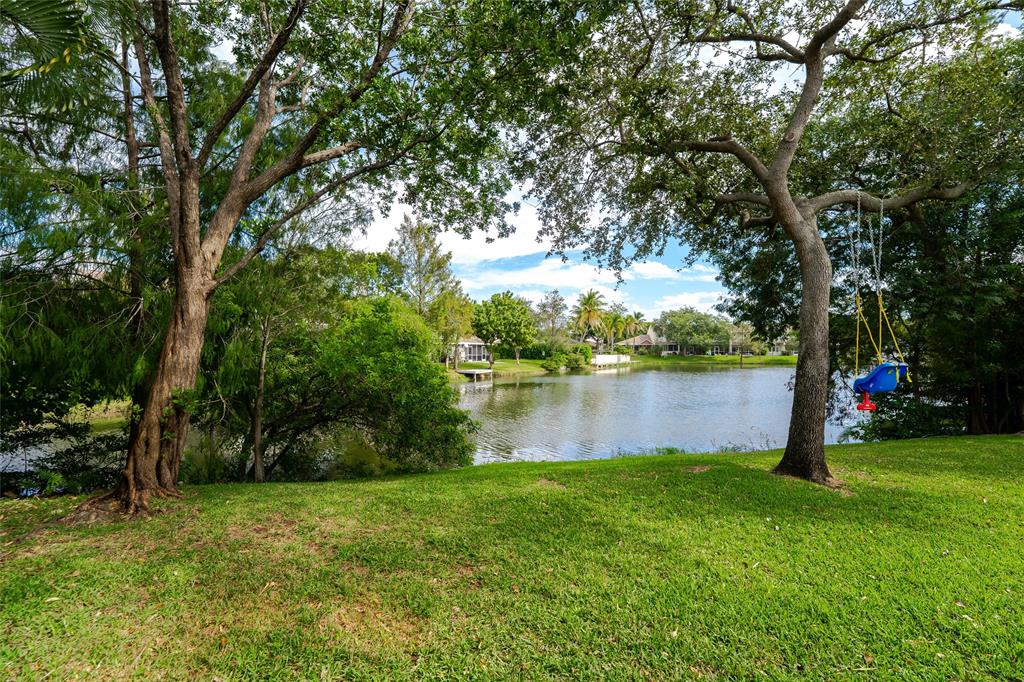 272 West Hemingway Circle Margate, FL 33063 - Photo 35 of 61 a backyard of a house with lots of green space and lake view